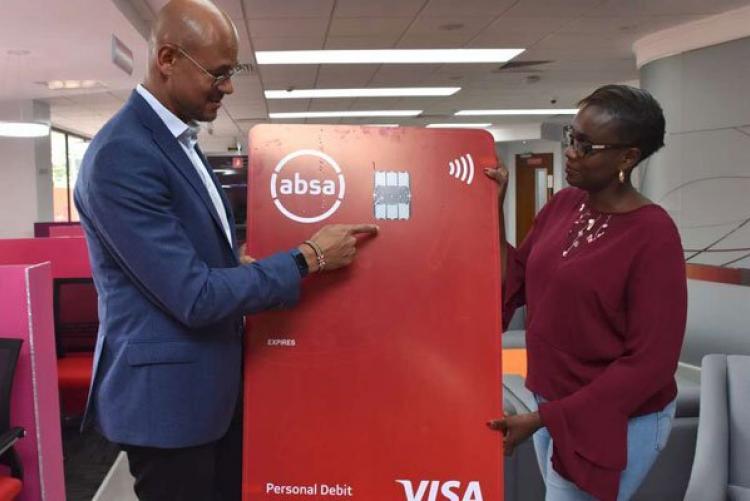 Jeremy Awori, Managing Director of Barclays Kenya, soon to be Absa, explains features of the new vertical Absa credit and debit cards to Sheila Momanyi, Manager Sarit Centre branch. PHOTO | FILE | NATION MEDIA GROUP 