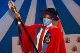 Prof. Kiama shows Public the University of Nairobi Mace as a symbol of Authority